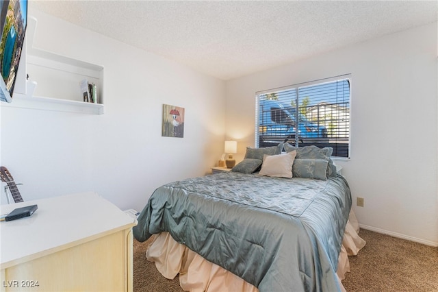 bedroom featuring a textured ceiling and carpet flooring