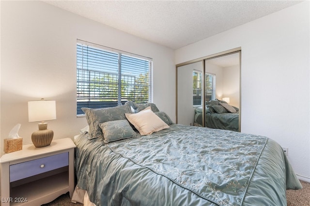 bedroom with carpet, a closet, and a textured ceiling