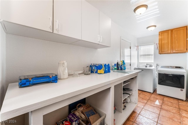 laundry room featuring cabinets and washing machine and dryer