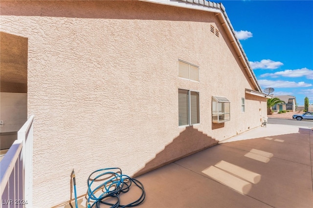 view of property exterior featuring a patio area