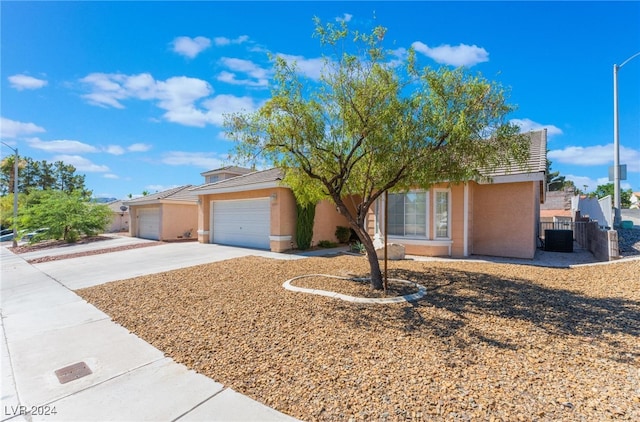 view of front of property featuring a garage and central air condition unit