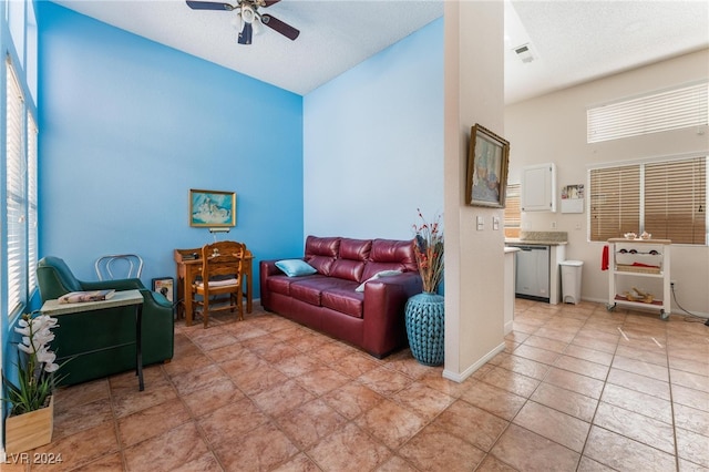 tiled living room featuring a healthy amount of sunlight and ceiling fan