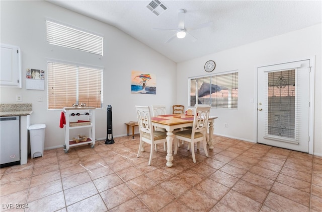 dining space with light tile patterned floors, lofted ceiling, and ceiling fan