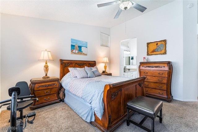 bedroom featuring ceiling fan, ensuite bath, and light carpet