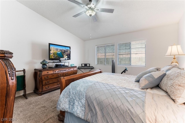 carpeted bedroom featuring ceiling fan, a textured ceiling, and lofted ceiling