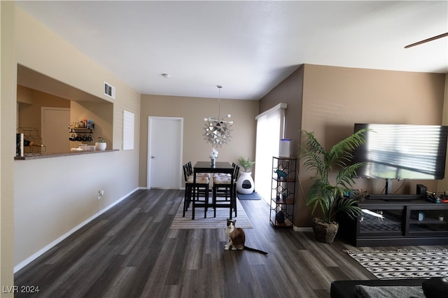 dining room featuring dark wood-type flooring and a chandelier