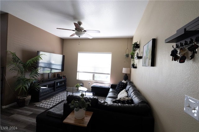 living room featuring dark hardwood / wood-style flooring and ceiling fan