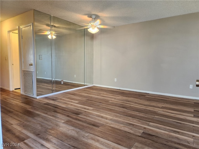 unfurnished bedroom with a textured ceiling, ceiling fan, and hardwood / wood-style flooring