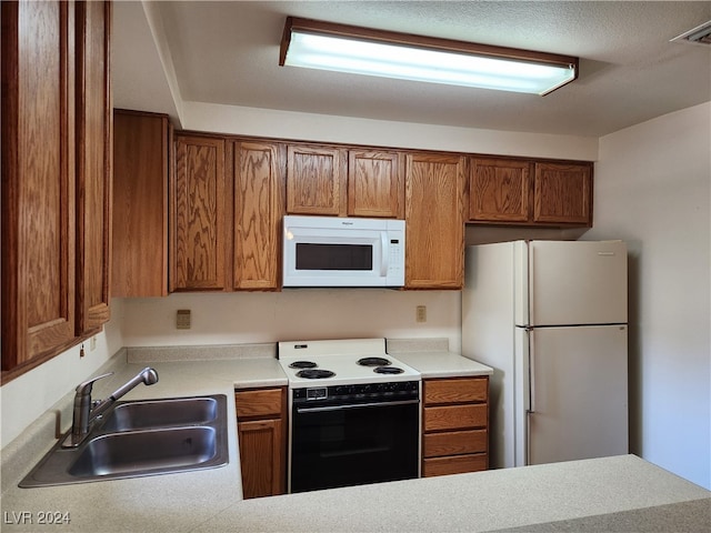 kitchen with sink and white appliances