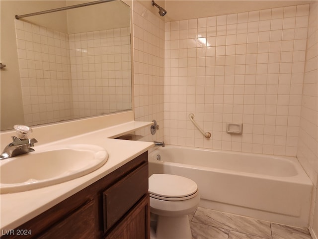 full bathroom featuring vanity, toilet, and tiled shower / bath