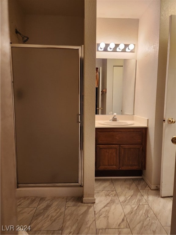 bathroom featuring walk in shower and vanity