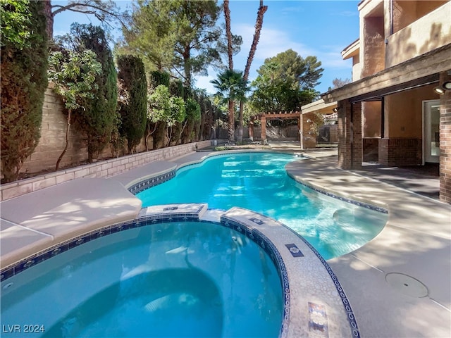 view of swimming pool with an in ground hot tub and a patio area