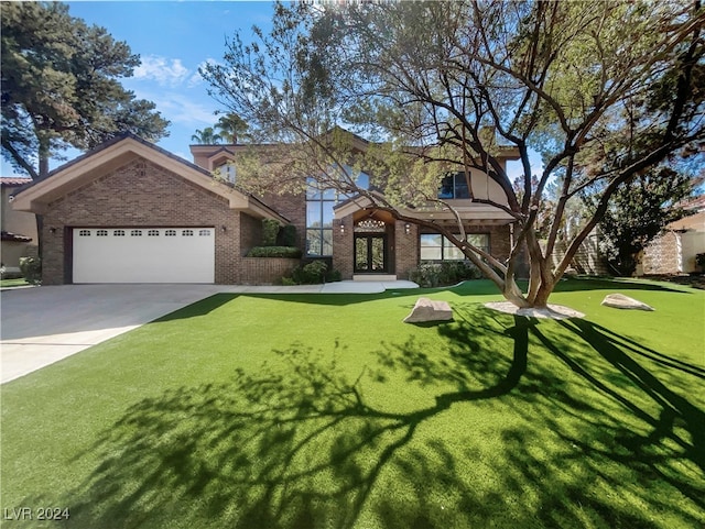 view of front of house featuring a front yard and a garage