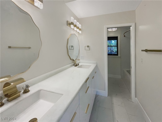 bathroom featuring  shower combination and vanity