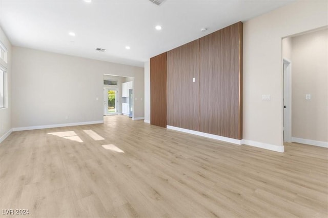 unfurnished living room with recessed lighting, visible vents, baseboards, and light wood-style flooring
