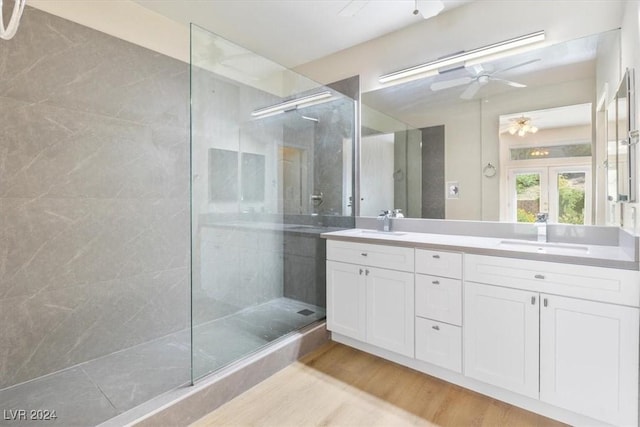 full bathroom featuring walk in shower, a sink, ceiling fan, wood finished floors, and french doors