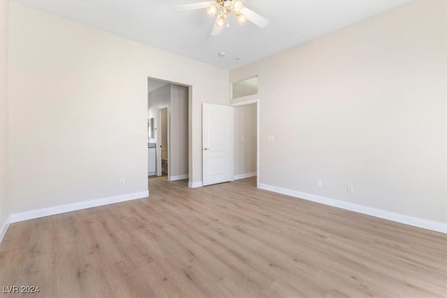 spare room with light wood-style flooring, baseboards, and a ceiling fan