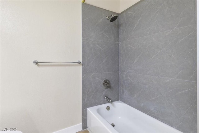 full bathroom featuring baseboards and shower / bathtub combination