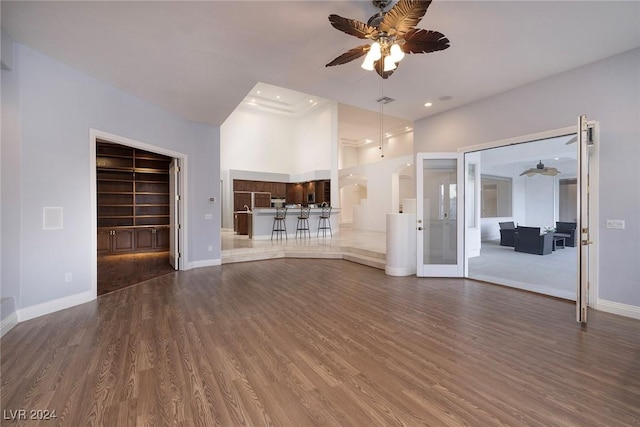 7421 Silver Palm Ave, Las Vegas, NV 89117 - unfurnished living room featuring baseboards, ceiling fan, wood finished floors, and french doors