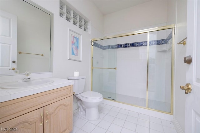 7421 Silver Palm Ave, Las Vegas, NV 89117 - full bathroom featuring a stall shower, toilet, tile patterned flooring, and vanity