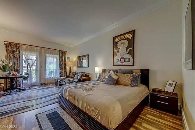 bedroom featuring access to outside, hardwood / wood-style flooring, and ornamental molding