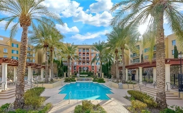 view of pool with a pergola and a patio area