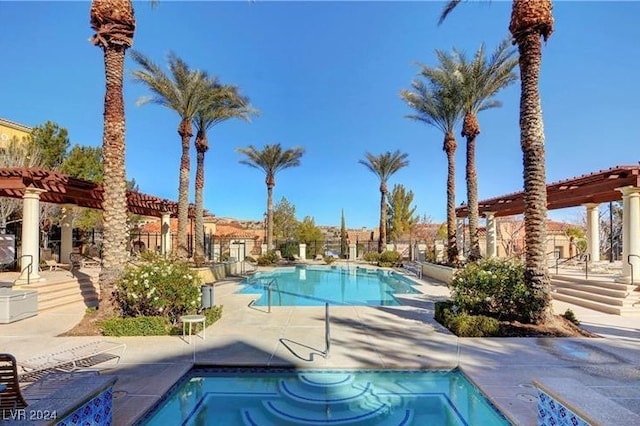 view of swimming pool with a patio and a pergola