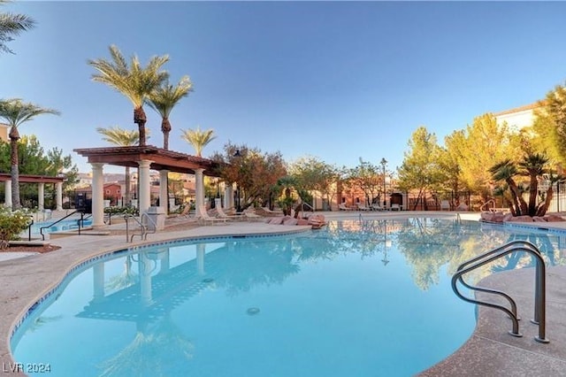 view of swimming pool featuring a patio and a pergola