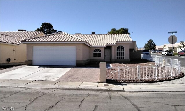 mediterranean / spanish-style house with a garage