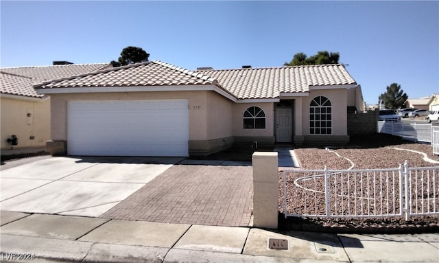 mediterranean / spanish house with a garage