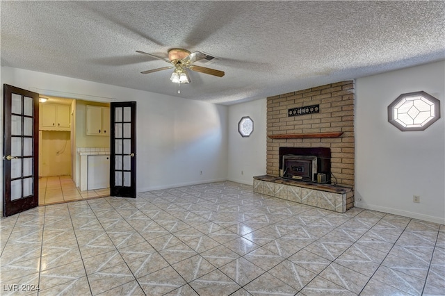 unfurnished living room with french doors, a textured ceiling, plenty of natural light, and ceiling fan