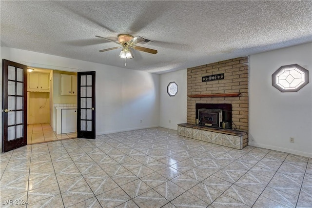 4842 E Imperial Ave, Las Vegas, NV 89104 - unfurnished living room featuring ceiling fan, french doors, light tile patterned floors, plenty of natural light, and a textured ceiling