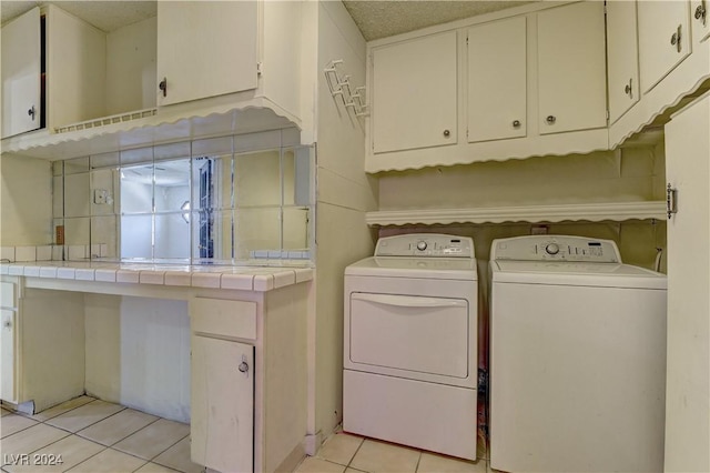 4842 E Imperial Ave, Las Vegas, NV 89104 - washroom with washer and clothes dryer, light tile patterned floors, and cabinet space