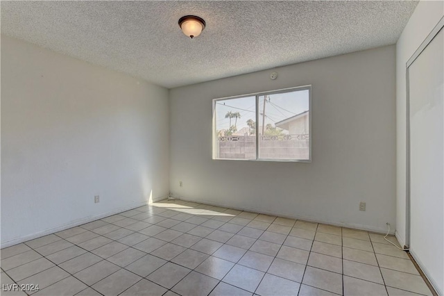 4842 E Imperial Ave, Las Vegas, NV 89104 - unfurnished room featuring a textured ceiling and light tile patterned flooring