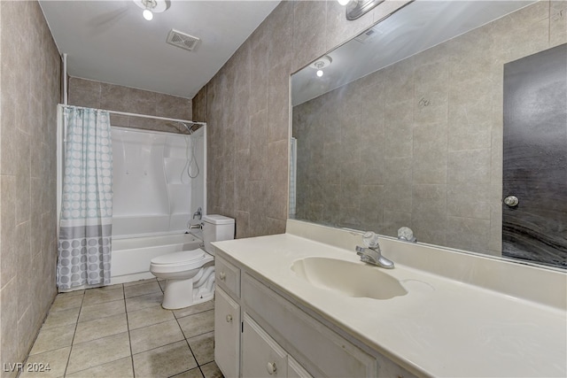 full bathroom featuring vanity, tile patterned floors, tile walls, toilet, and shower / tub combo with curtain