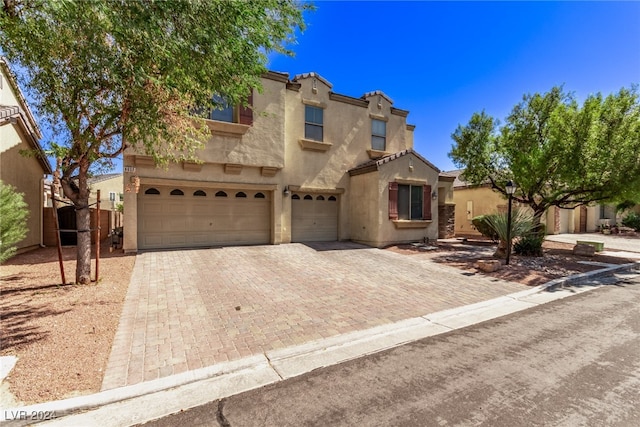 mediterranean / spanish-style home with a garage