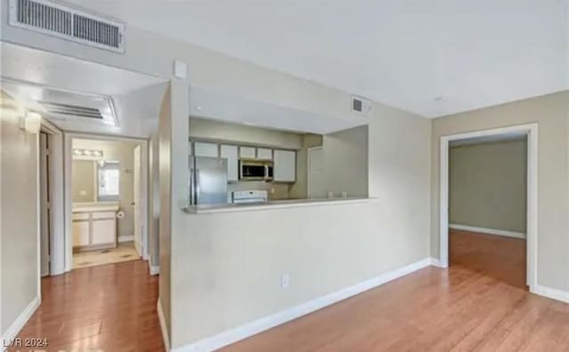 kitchen featuring stainless steel appliances and light hardwood / wood-style floors