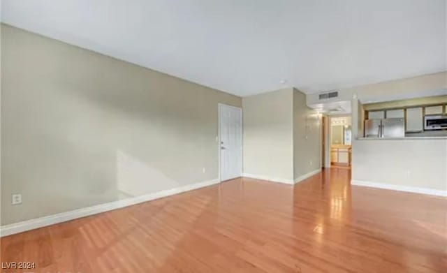 unfurnished room featuring hardwood / wood-style flooring