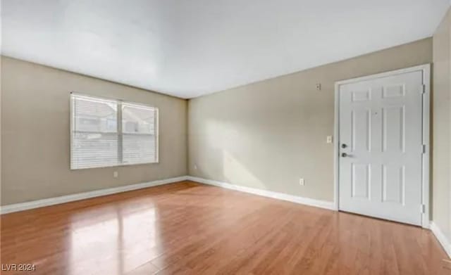 spare room with hardwood / wood-style flooring