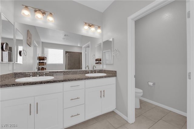 bathroom with tile patterned floors, a shower, vanity, and toilet