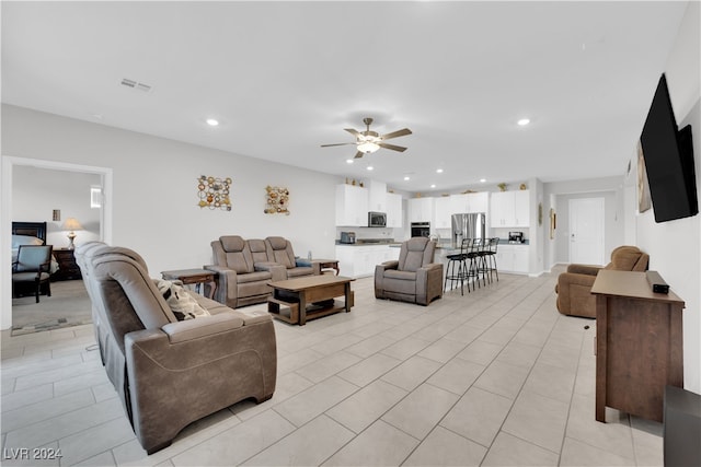 living room with ceiling fan and light tile patterned flooring