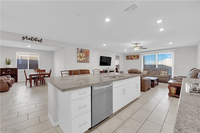 kitchen featuring a center island, sink, stainless steel dishwasher, ceiling fan, and white cabinetry