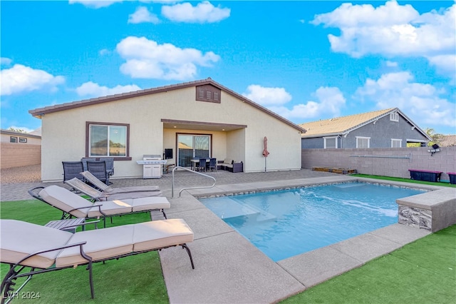 view of swimming pool with a patio and grilling area