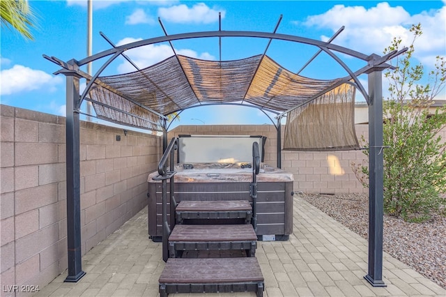 view of patio / terrace with a hot tub