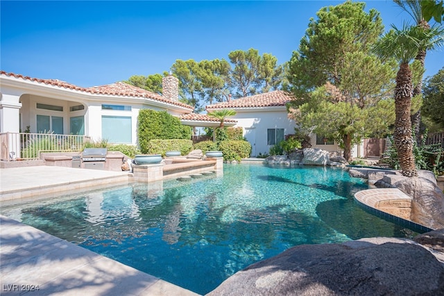 view of pool with a patio and area for grilling