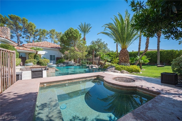 view of swimming pool featuring an in ground hot tub and a patio area