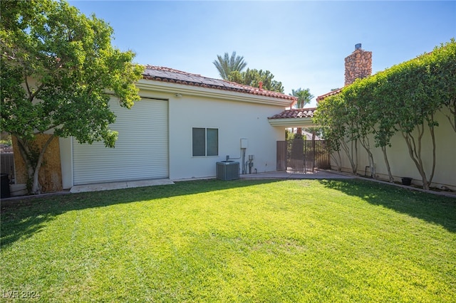 back of house with a yard and a patio