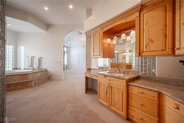 kitchen with ornamental molding, sink, stone countertops, and light carpet