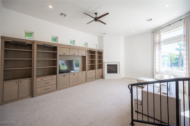 living room with light carpet, a fireplace, and ceiling fan