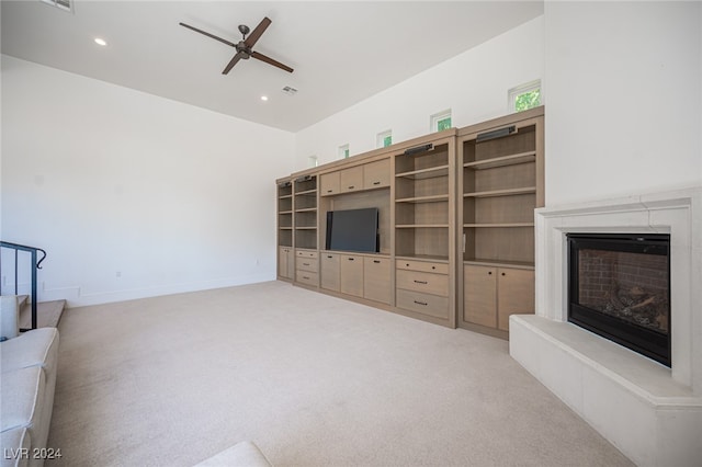 unfurnished living room featuring ceiling fan